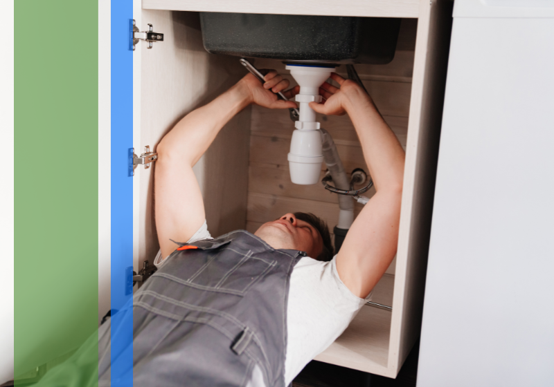 Plumber under a sink performing repairs