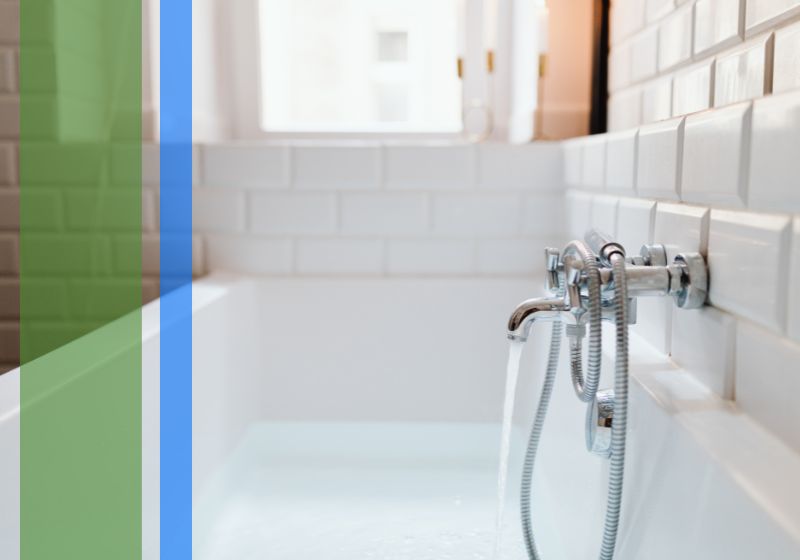 Water running smoothly from the faucet of a white bathtub