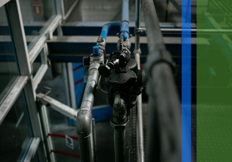 A close-up of a drain pipe with a water meter on the side.