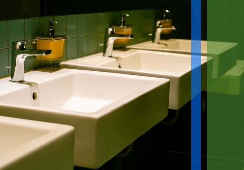 Two white ceramic sinks in a bathroom setting.