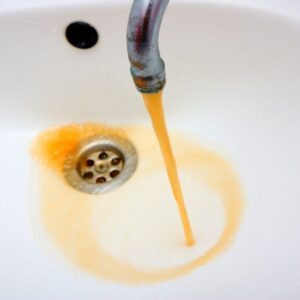 discolored water pouring out of a faucet