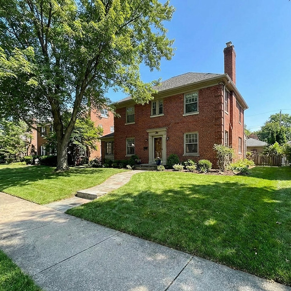 brick home with green lawn
