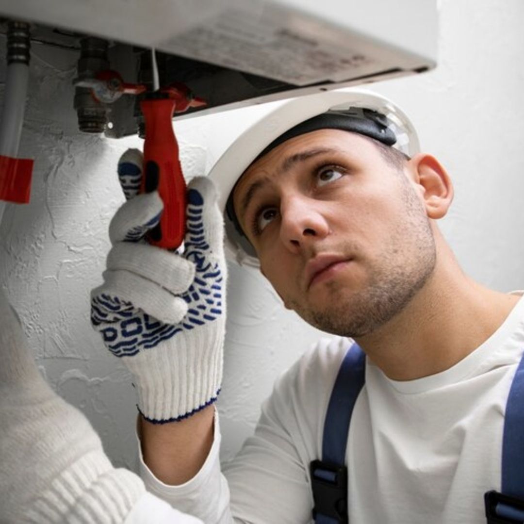 plumber working on a tankless water heater