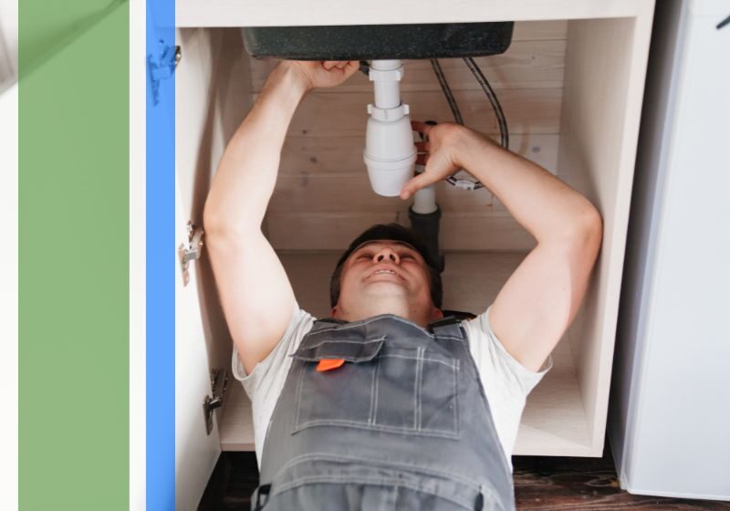 A plumber working under a sink