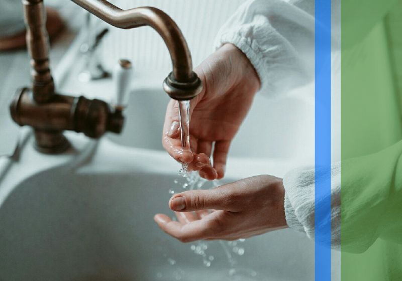 A woman washing her hands in a nice sink