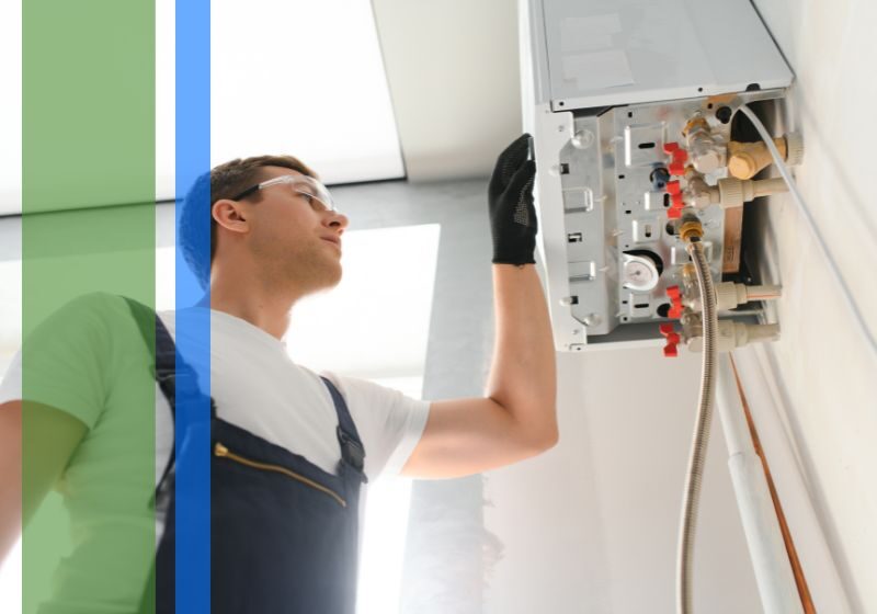 A plumber working on a water heater