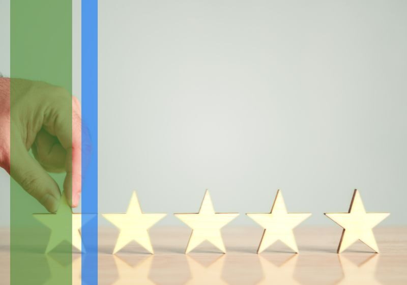 A person touching a line of five stars to symbolize reviews